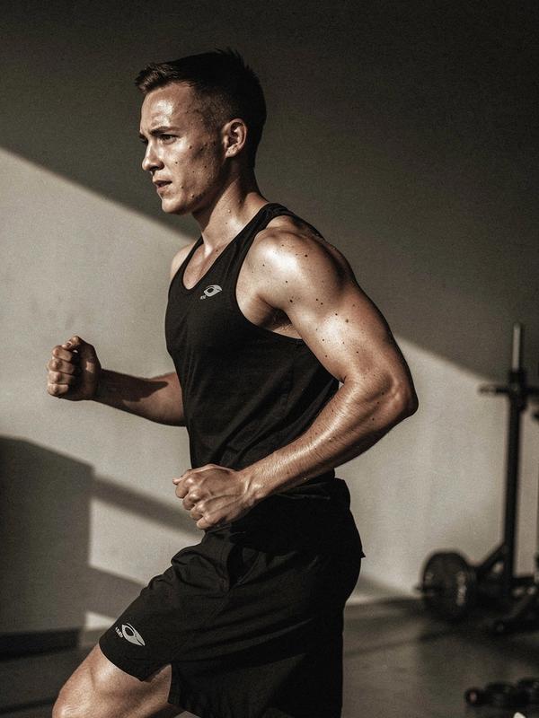 Athlete training in a minimalist studio with strong contrast